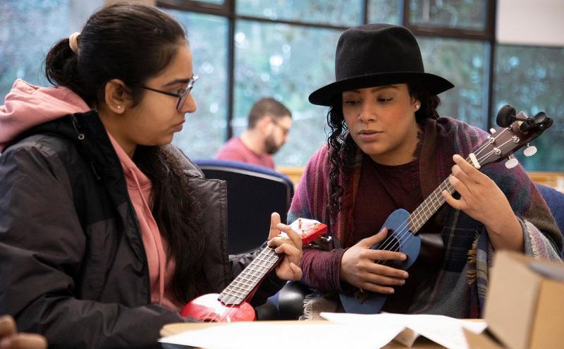 CapU employees building their own ukuleles.