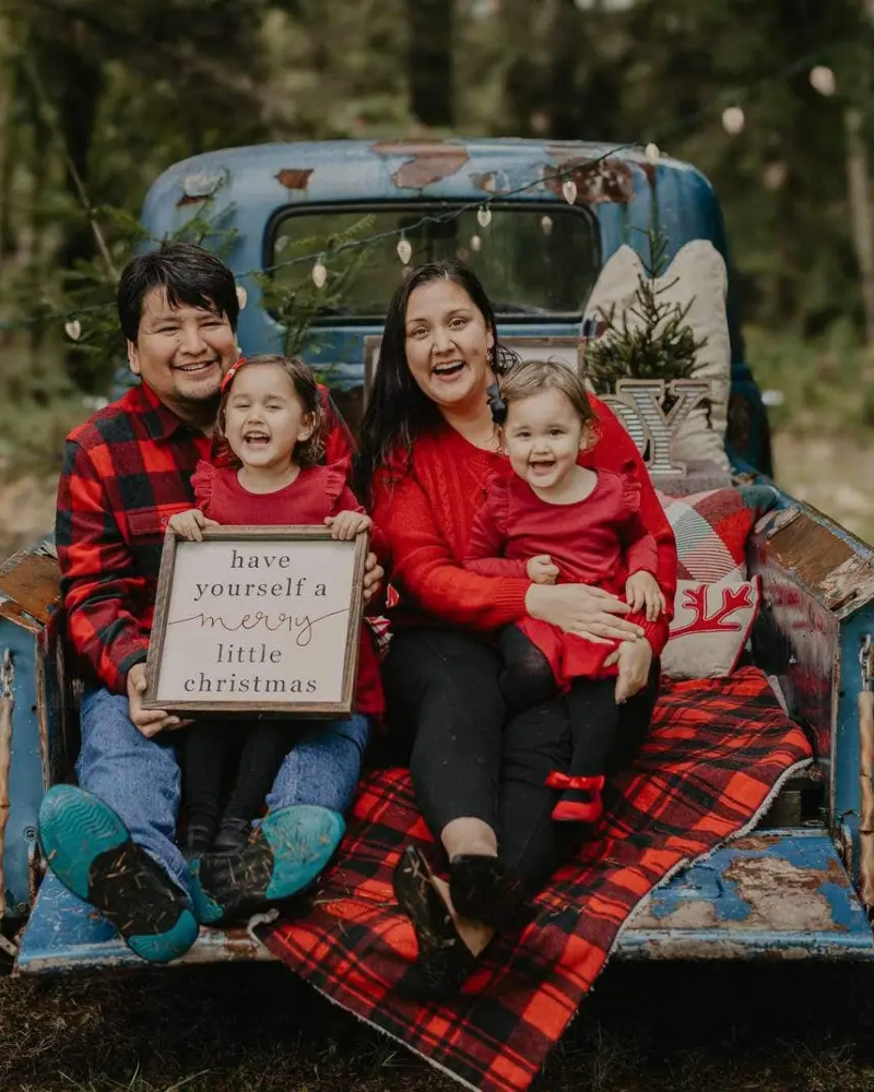 Mason Ducharme with his family during a typical rainy Vancouver Island Christmas photoshoot. Sitting on Mason's lap is his and his wife Rikki’s eldest daughter, Riel Ducharme, while Rikki holds their youngest daughter, Macy Ducharme