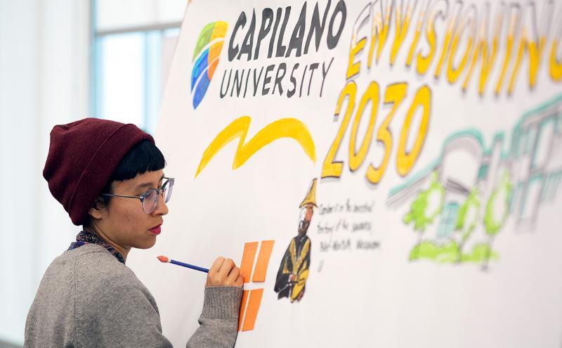 Student drawing on board