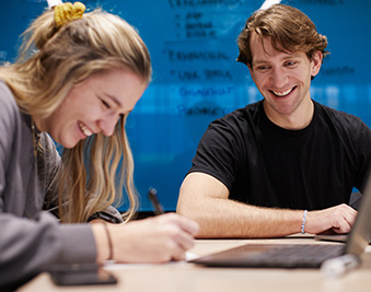 CapU business students working on a project.