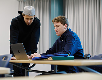 CapU business students working on their laptop.